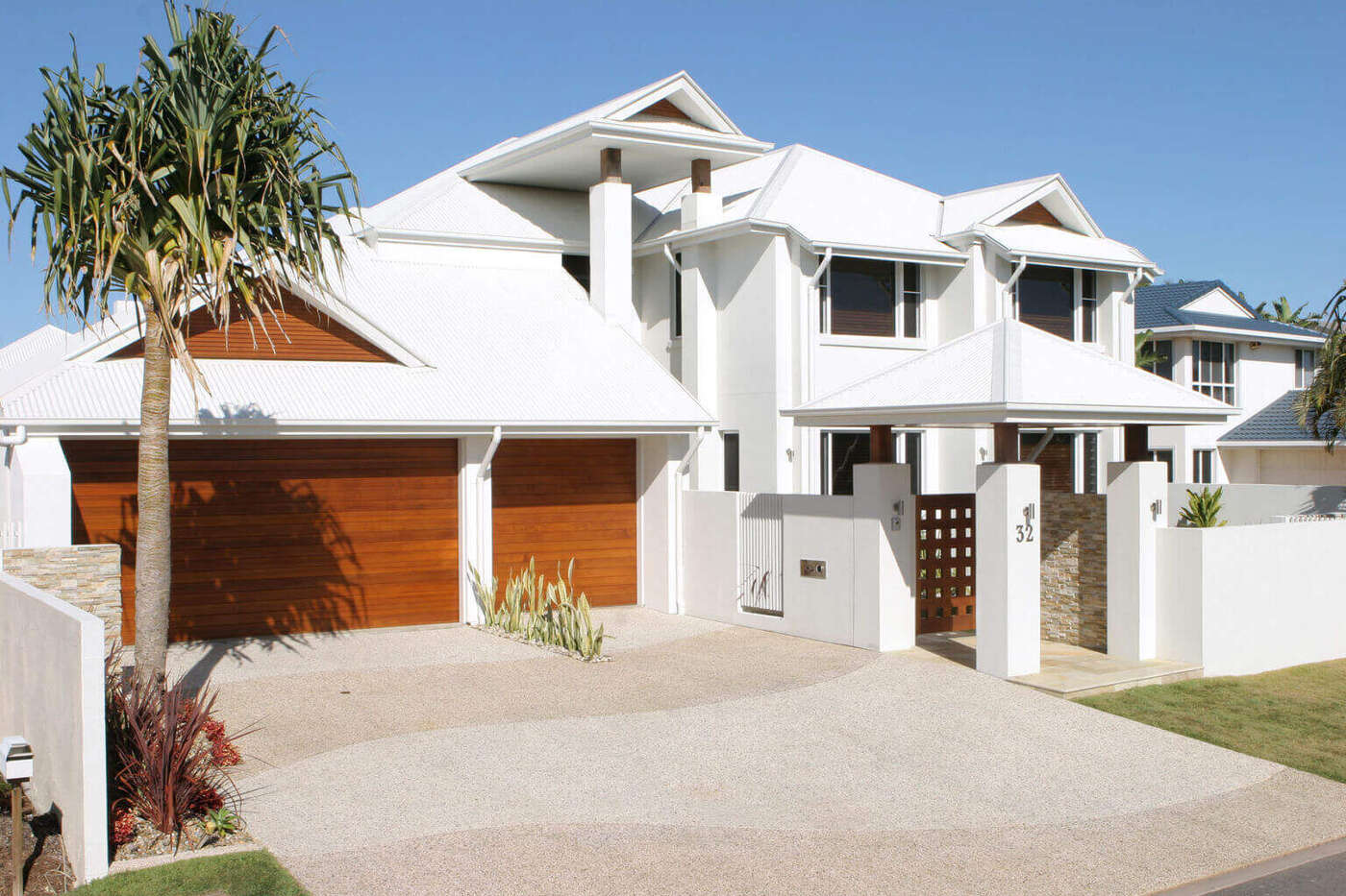 Pressure cleaning removing oil stains and grime from a concrete driveway